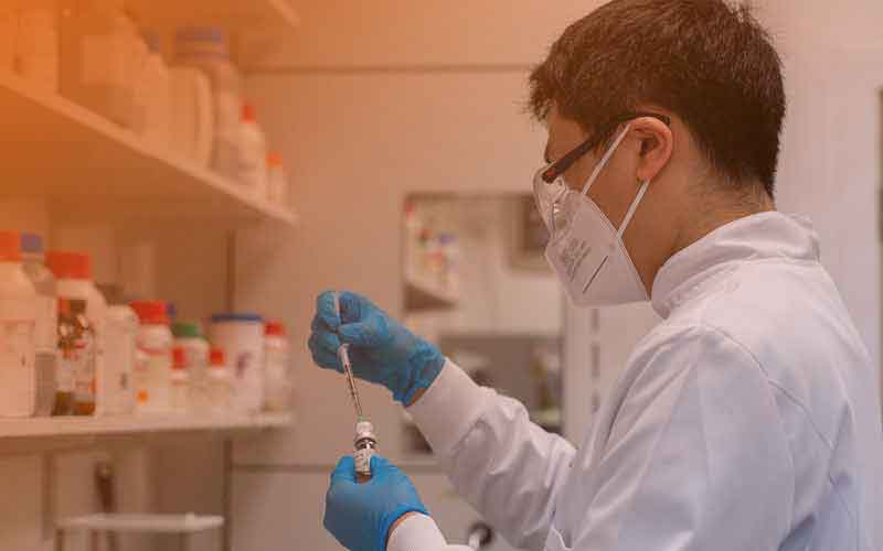 three people in a lab having a discussion